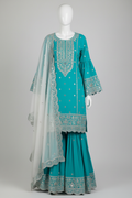 Turquoise gharara suit with silver embroidery on mannequin